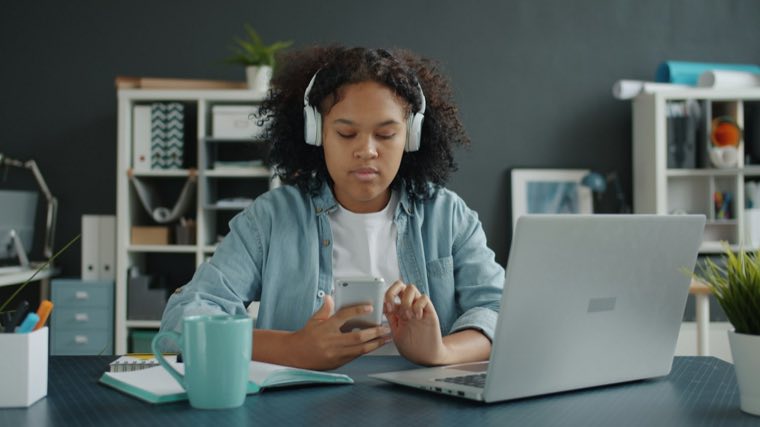 Student in headphones at a laptop