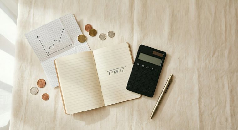 Notebook, calculator and coins