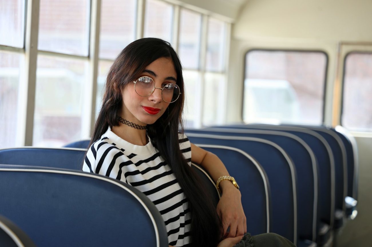Young woman by a window on a bus