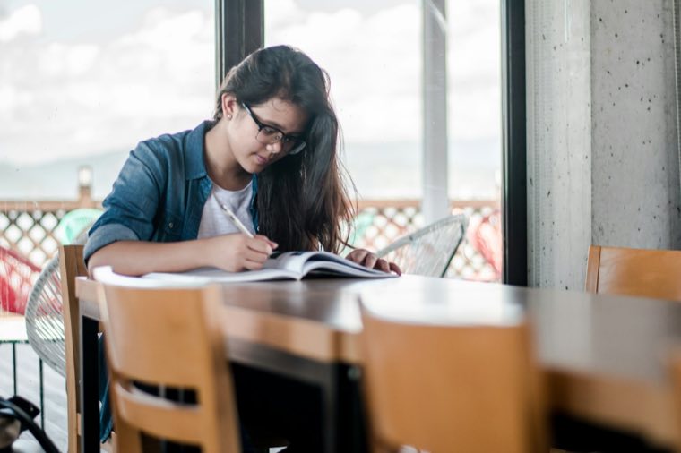 Student at a desk by a window