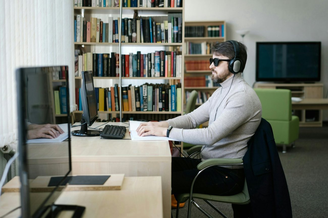 Young man working at a desk in headphones