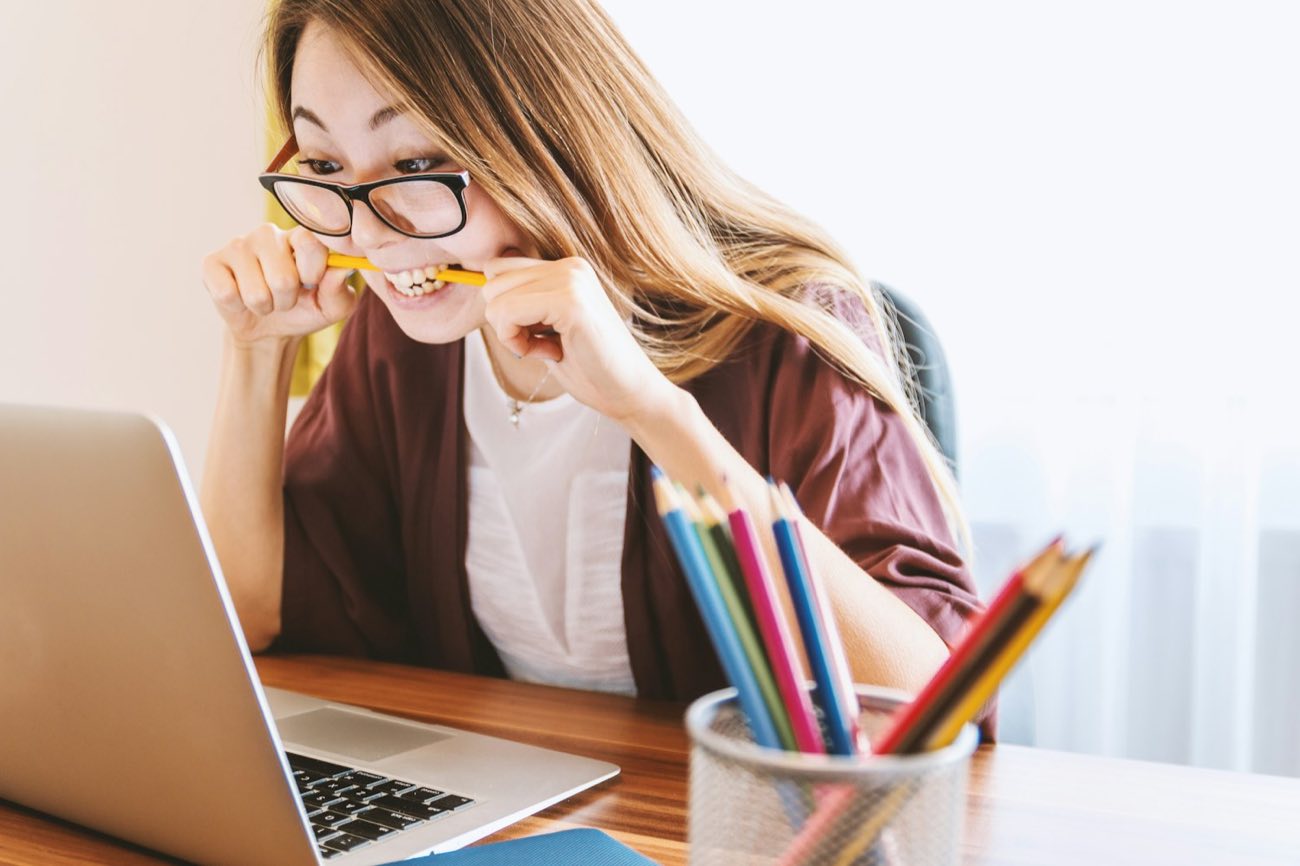 Young woman studying with colored pencils