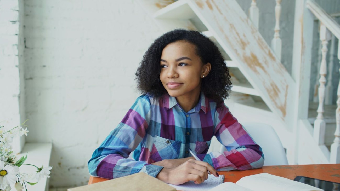 Student in a plaid shirt studying