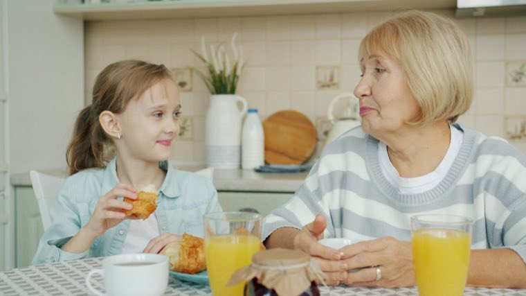 Older woman and a girl at a kitchen table