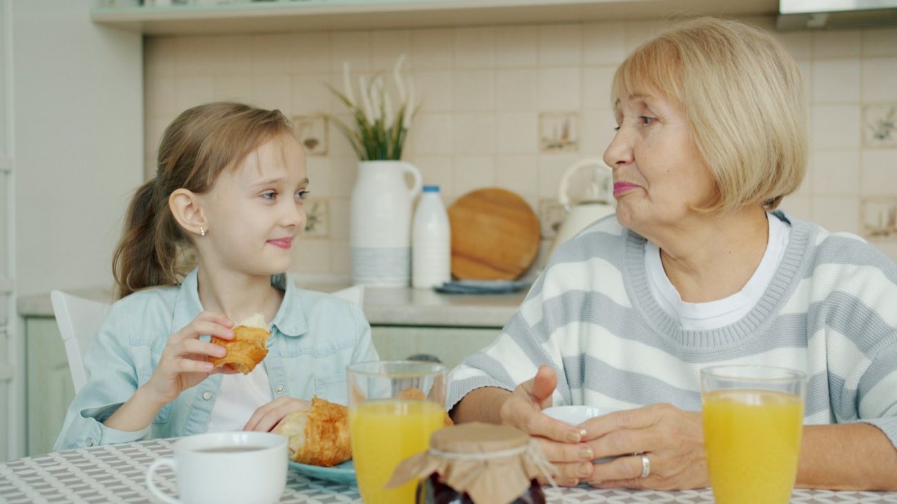 Older woman and a girl at a kitchen table