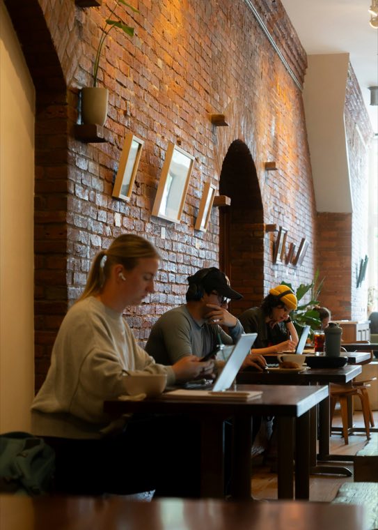 People with laptops in a cafe