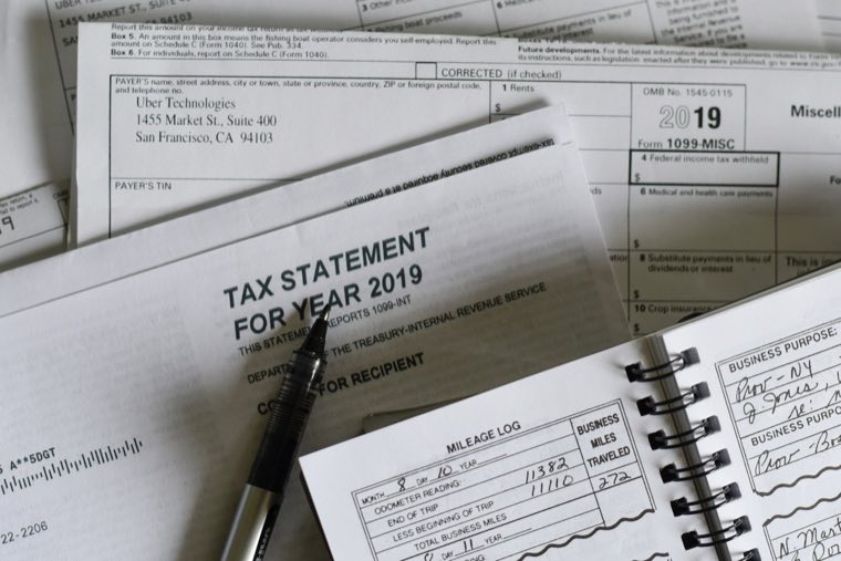 Tax statement beside a notebook
