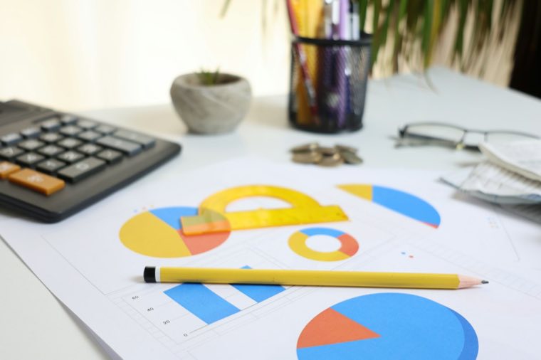 Charts and a calculator on a desk