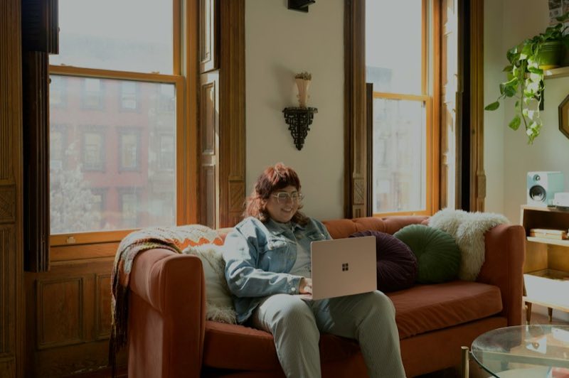 Young man with a laptop on a sofa