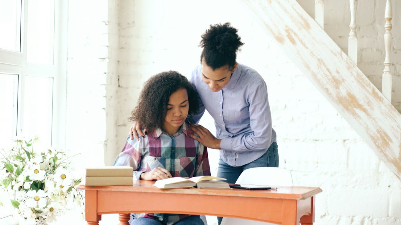 Tutor helping a student at a desk