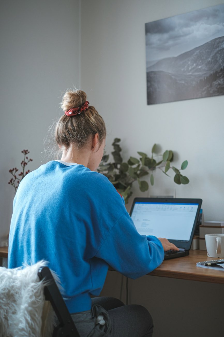 Student working on a laptop at home